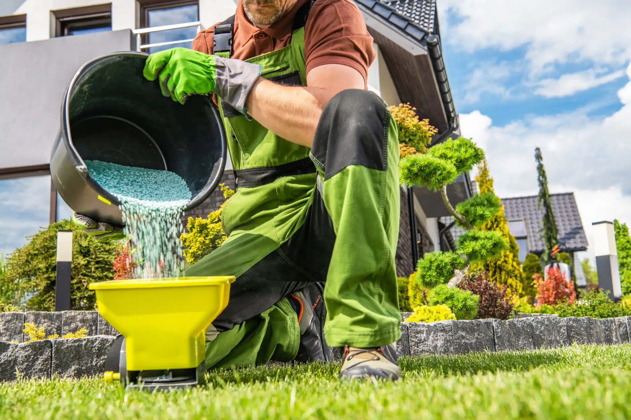 garden worker preparing fertilizer - Photo - NG Turf